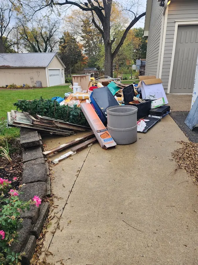 Dumpster being loaded with debris for Residential Dumpster Rental in Suwanee